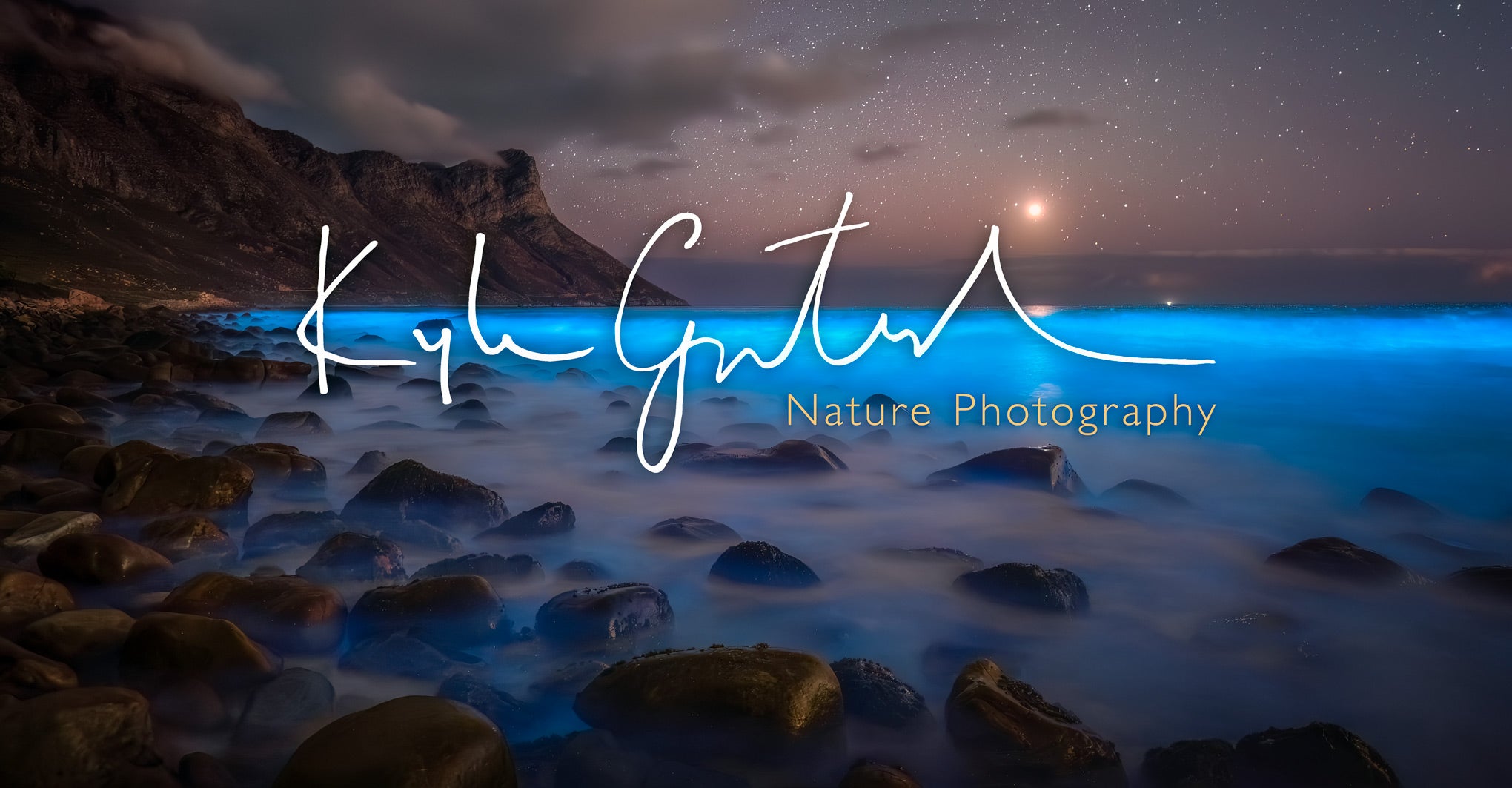 Starry night sky over a rocky coastline with 'Kyle Goetsch'